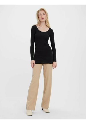 Black long-sleeve top with a scooped neckline, paired with beige wide-legged pants and cream-colored heeled shoes. Simple design, smooth texture.