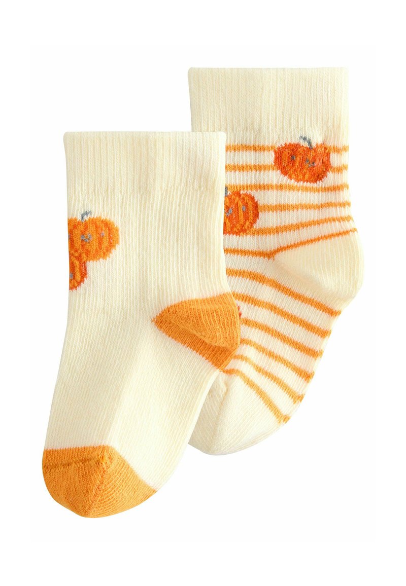 Cream socks with orange pumpkin designs; one features a solid toe, the other has orange stripes. Soft texture, mid-calf length.