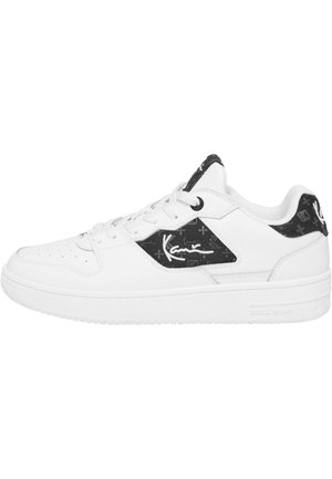 White sneakers with a textured upper, featuring black accents and a signature logo on the side. Low-top design with perforated details.