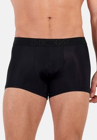 Black boxer briefs with a soft waistband featuring the brand name "HOM" in subtle black lettering. Smooth fabric with a fitted design.