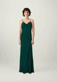 Langes, smaragdgrünes Kleid mit Spaghetti-Trägern und verziertem Oberteil. Besitzt ein drapiertes Design und einen Seitenschlitz für zusätzlichen Detailreichtum.