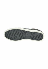 Suola di scarpa da ginnastica nera con gomma texturizzata per la presa, caratterizzata da un bordo bianco e un logo circolare al centro.