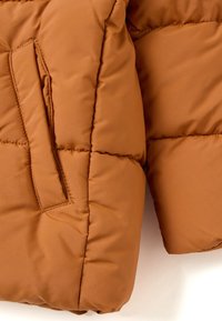 Brown puffer jacket featuring a smooth, matte finish, stitched design, and a side pocket on the front near the hem.