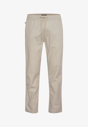 Beige letvægtsbukser med en elastisk talje, justerbar snor og tapered ben. Fremstillet af et blødt, åndbart stof.