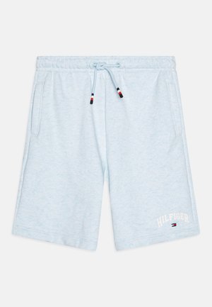 Light blue sweat shorts made of soft fabric with an elastic waistband, drawstring, and side pockets. Features white text "HILFIGER" and logo.