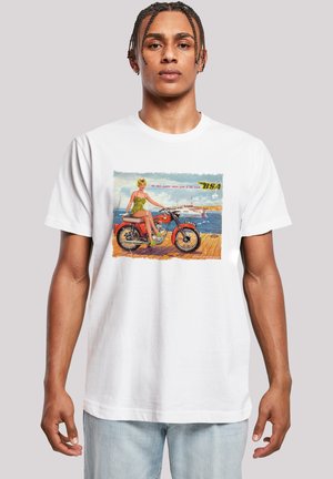 White cotton t-shirt featuring a retro print of a woman on a motorcycle. Colors include green, orange, and blue with vintage text.