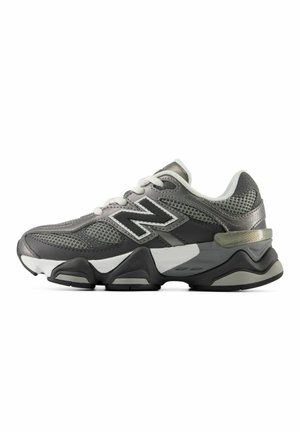 Gray and black athletic sneaker with white laces, breathable mesh, and thick sole featuring the New Balance logo on the side.