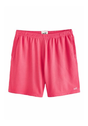 Pantaloni scurți cu talie elastică roz aprins, buzunare laterale și un mic logo alb „self.” pe partea dreaptă jos a piciorului.