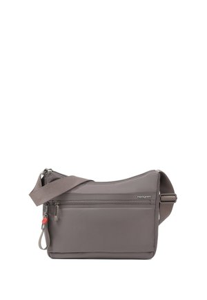 Petit sac bandoulière gris avec poche zippée à l'avant, sangle réglable et logo Hedgren sur le devant.