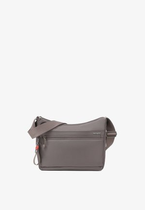Petit sac bandoulière gris avec poche zippée à l'avant, sangle réglable et logo Hedgren sur le devant.