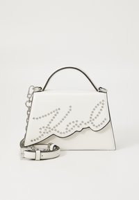 White leather handbag with a scalloped design, silver studded lettering, and a detachable silver chain strap. Smooth texture and structured shape.