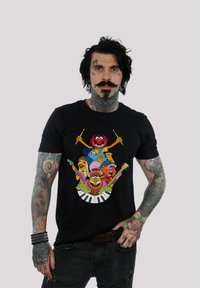 Black cotton t-shirt featuring colorful cartoon characters with musical instruments against a white keyboard graphic. Regular fit.