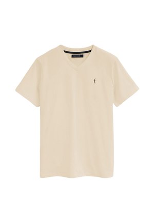 Beżowa koszulka polo z krótkim rękawem i dekoltem w serek, z małym czarnym logo gracza polo na lewej piersi oraz czarną metką wewnątrz kołnierzyka.