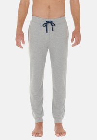 Grå sweatpants i mjukt tyg, med dragsko i midjan, sidofickor och ribbade ärmslut för en tät passform.
