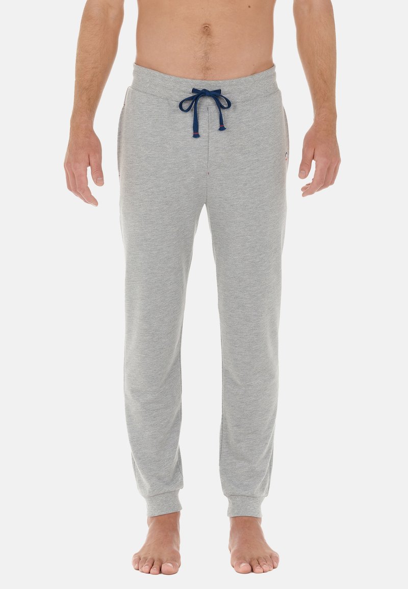 Grå sweatpants i mjukt tyg, med dragsko i midjan, sidofickor och ribbade ärmslut för en tät passform.