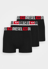 Boxer-briefs noirs avec une ceinture élastique blanche et rouge arborant le logo "DIESEL". Matière douce avec un design ajusté. Lot de trois.