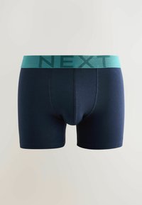 Pánske boxerky v námorníckej modrej farbe s tyrkysovým elastickým pásom, na ktorom je nápis NEXT tmavším tyrkysovým písmom.