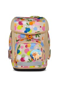 Sac à dos beige avec un motif coloré à pois. Il dispose d'une poche zippée avant, d'une forme arrondie et d'un badge de chien ludique à l'avant.