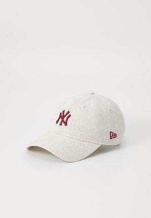 Light gray baseball cap with red embroidered logo, curved brim, and eyelet details; features texture in the fabric.
