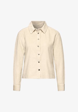 Light beige corduroy shirt jacket with a collared neck, front buttons, and long sleeves. Features vertical texture and a straight hem.