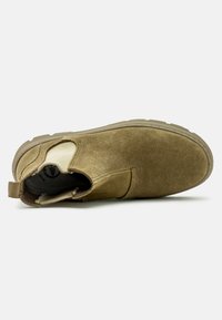 Stivale alla caviglia in suede marrone con pannello laterale elasticizzato, punta arrotondata e suola in gomma testurizzata. Include un tassello sul tallone per indossarlo facilmente.