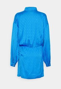 Blå satin skjortklänning med ett strukturerat diamantmönster, långa ärmar, knappmanschetter och en cinchad midja för en avslappnad silhuett.