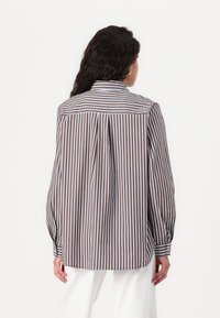 Striped button-up shirt in brown and light blue, featuring long sleeves, a classic collar, and a back pleat detail. Cotton fabric.