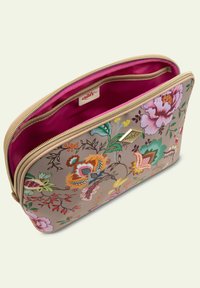 Bloemrijke cosmeticatas met een beige buitenkant, levendige multicolor bloemen, roze interieur en een gouden rits. Logo-label zichtbaar aan de binnenkant.