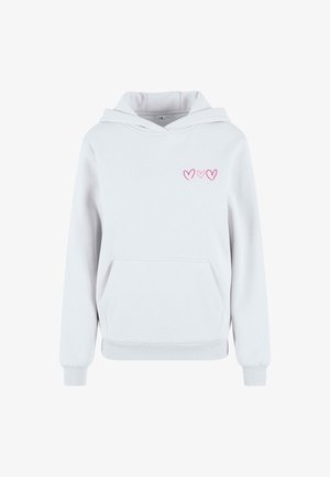 Valkoinen huppari pehmeästä materiaalista, jossa on etutasku, vaaleanpunainen sydänbrodeeraus ja klassinen nyörikiinnitteinen huppu.