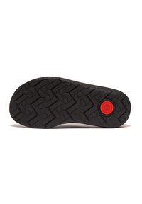 Zwarte rubberen schoenzool met een getextureerd grippatroon en een rode ronde logo in het midden. Voorzien van een zigzagprofiel voor grip.