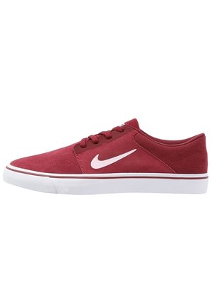 Rød Nike lavtop-sneaker med hvid swoosh-logo, hvid gummisål og matchende røde snørebånd, vist fra siden på en hvid baggrund.