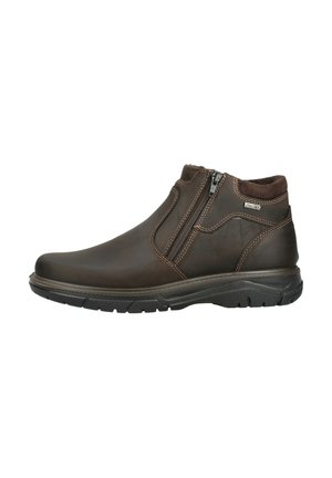 Brauner Leder-Stiefelette mit seitlichem Reißverschluss, dunkler Sohle, gepolstertem Kragen und sichtbaren Ziernähten.