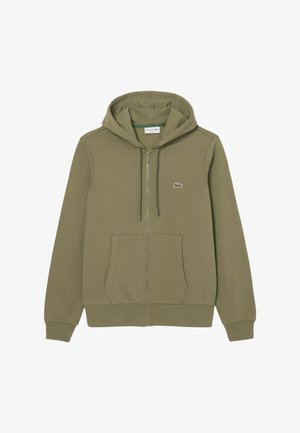 Felpa con zip verde oliva realizzata in tessuto morbido, con una tasca a marsupio e un piccolo logo Lacoste sul lato sinistro del petto.