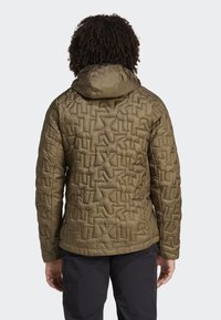 Olive green insulated jacket with a textured, geometric pattern. Features a hood and elastic cuffs, providing a secure fit for outdoor use.