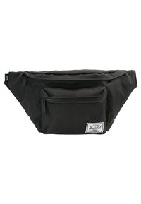 Sac banane Herschel en tissu noir avec deux compartiments zippés et une étiquette de marque blanche rectangulaire sur la poche avant.