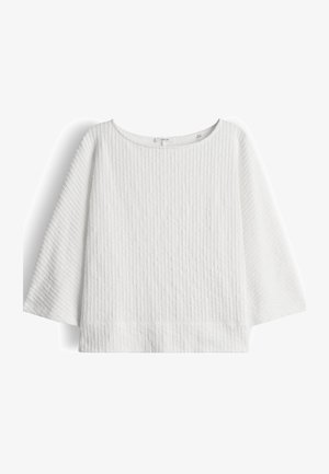 White knit sweater with vertical ribbed texture, three-quarter bell sleeves, and a round neckline.