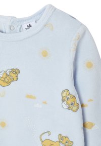 Helles blaues Fleece-Oberteil mit gelben Löwengrafiken, die Sonnen und Wolken zeigen, Rundhalsausschnitt und Druckknopfverschluss an der Schulter für ein einfaches An- und Ausziehen.