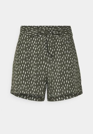 Green shorts with white irregular dot pattern and a matching fabric belt tied in a bow at the waist.