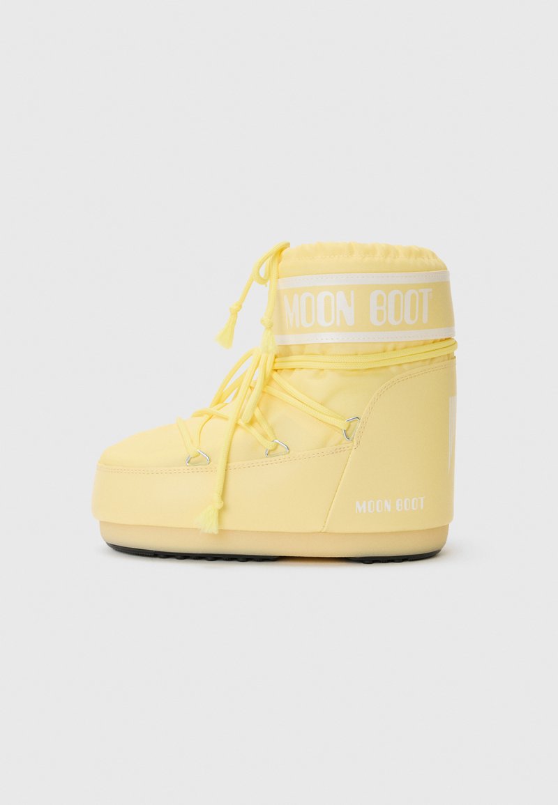Yellow Moon Boot with a padded upper, drawstring closure, and rubber sole. Features white logo accents and a soft, smooth texture.