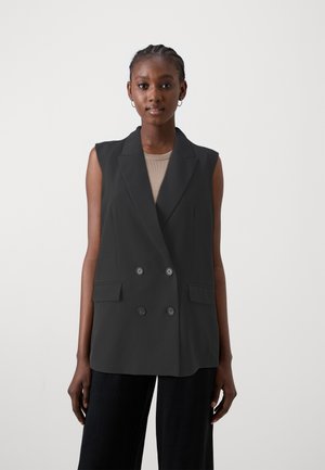 Black sleeveless blazer with a double-breasted design, notched lapels, and front pockets. Smooth fabric and structured shape.