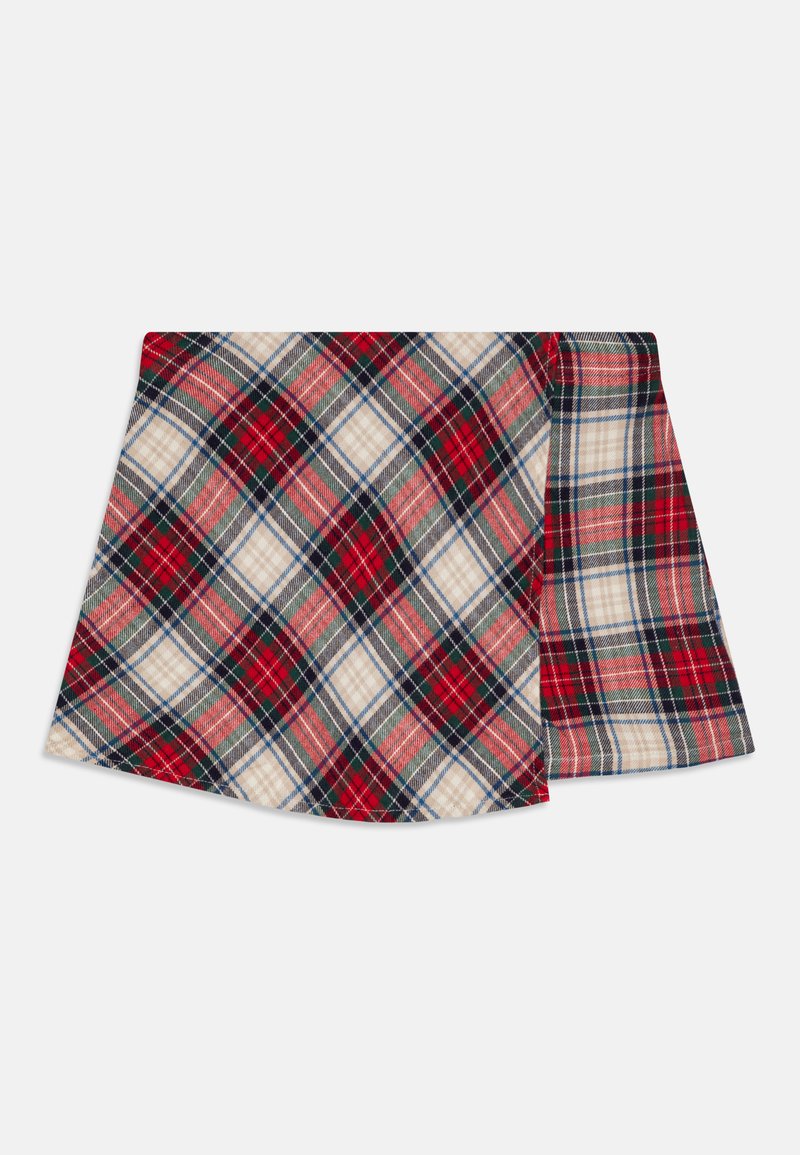 Kockás szoknya piros, zöld és sötétkék vonalakkal bézs alapon, fodros szegéllyel és textúrált anyaggal, amely réteges megjelenést kölcsönöz.
