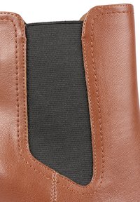 Brown leather upper with a black elastic side panel. Textured surface with visible stitching detailing. Designed for slip-on wear.