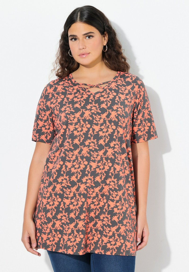 Top con estampado floral que presenta un fondo gris con flores naranjas, mangas cortas y un escote en V con detalle entrelazado. Tejido suave.