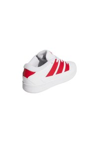 White sneaker with red stripes and red heel accent, showing side and back view on a white background.