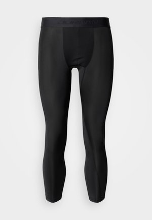 Črne športne pajkice iz raztegljivega materiala z gladko teksturo in širokim pasom z nežnim logotipom blagovne znamke.