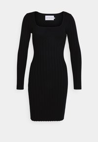 Black ribbed dress with a squared neckline and long sleeves. Fitted silhouette and scalloped hem. Label reads "Calvin Klein Jeans."