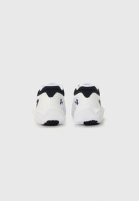 White and black athletic shoes with a smooth upper, rounded shape, contrasting heel accents, and a textured rubber outsole for traction.
