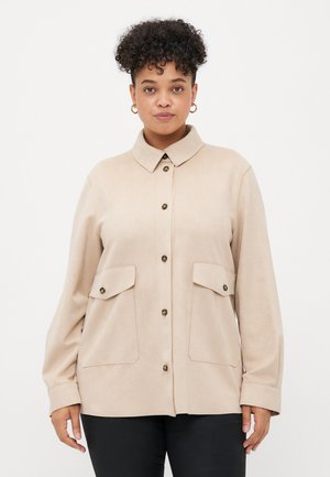 Beige button-up shirt made of soft fabric, featuring a collar, two front pockets, and gold-tone buttons. Long sleeves with cuffs.