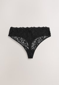 String femme en dentelle noire avec motifs floraux et taille festonnée sur fond clair.