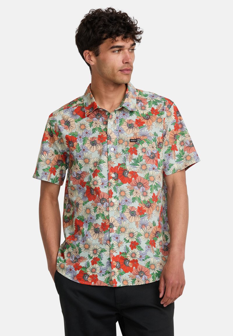 Short-sleeve button-up shirt in light fabric, featuring a vibrant floral pattern with red, orange, and purple flowers on a light background.